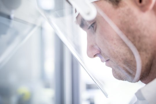 Lab technician wearing face shield