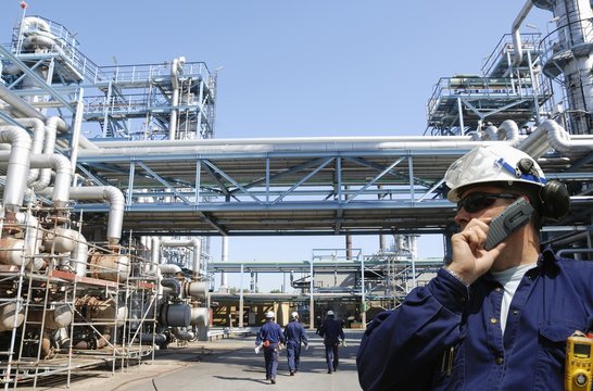 Workers inside refinery