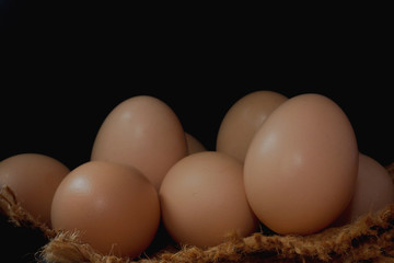 Eggs in a nest on hemp sack, dark corner