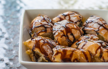 Chocolate and condensed sweet milk crunchy toast cut into pieces on white square bowl