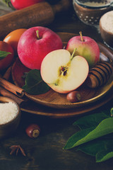 Apple baking concept. Fresh red apples and ingredients for baking on a wooden table. Copy space. Toned image.
