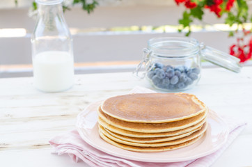 Vintage pancakes outside garden with blueberries