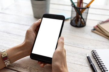 hand woman using a telephone, empty screen smart phone and computer on wooden table In home office. with clipping path