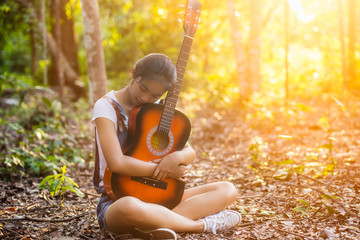 Women in the wild play guitar.