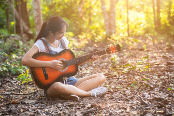 Women in the wild play guitar.