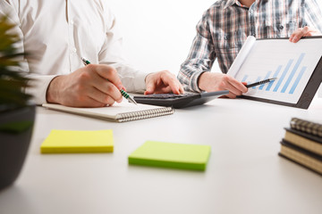 Business concept. Two business mans working and meeting with chart at office on his desk.
