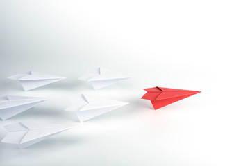 Leadership concept with red paper plane leading among white.