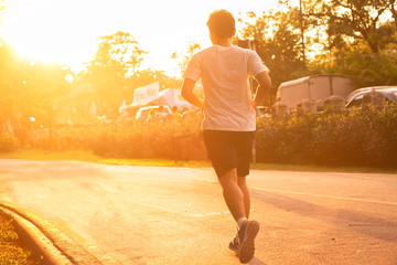 Young boy running on  public road during sunset