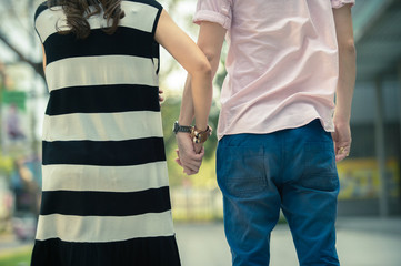 Valentine couples walk hand in hand and walk along the walkway 