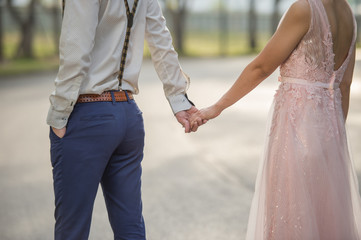 Valentine couples walk hand in hand and walk along the walkway 