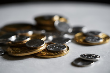 Macro shot detail of golden and silver color coin stacks on dark background with copy space for text. Business and finance growth, saving money, investment and interest concept.