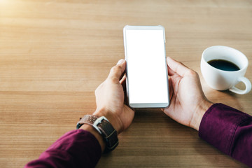 Mockup image of man's hands holding white mobile phone with blank screen technology and lifestyle concept.