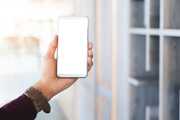 Mockup image of man's hands holding white mobile phone with blank screen technology and lifestyle concept.