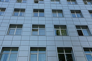 texture of a row of windows on a gray wall of a building