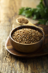 Raw buckwheat in the wooden bowl