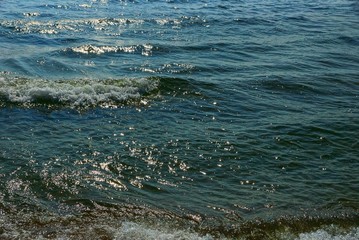 blue green water texture from sea waves and white foam