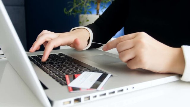 4k video of young businesswoman having issues wuth credit cards while doing online purchaes at the internet store