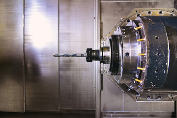CNC drilling, tuning and turning metal with a cutting tool and centering tool. The concept of...