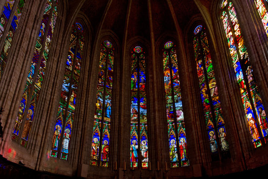 Colorful stained glass windows in the apse of the cathedral of Saint-Fulcran in Lodeve, France