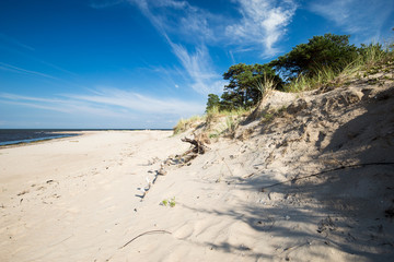 Clouds and wind over the sandy empty beach
