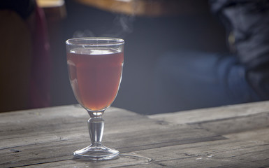 a glass of mulled wine on an old wooden table