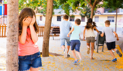 playing hide and seek.  Girl covering eyes her hands