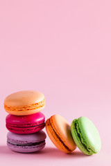 Still life and food photo of cake macarons in a gift box with flowers, a cup of tea on light background. Sweets and desserts concept of macaroons.