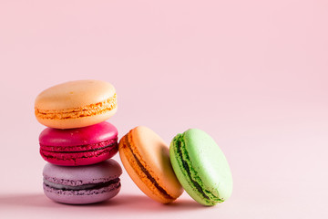 Still life and food photo of cake macarons in a gift box with flowers, a cup of tea on light background. Sweets and desserts concept of macaroons.