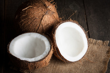 Ripe half cut coconut on a wooden background. Ripe half cut coconut on a wooden background. Coconut cream and oil.