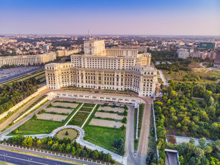 Parliament building or People's House in Bucharest city. Aerial view at sunset with blue sky - obrazy, fototapety, plakaty