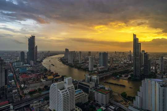 aerial view of sunset cityscape with curve of river © bank215