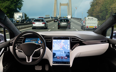 Fototapeta premium Self driving car on a road. Autonomous vehicle. Inside view.