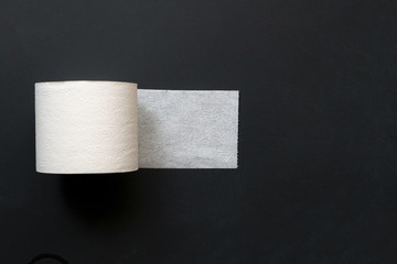 close up hand grab take the toilet paper roll on dark black surface a
