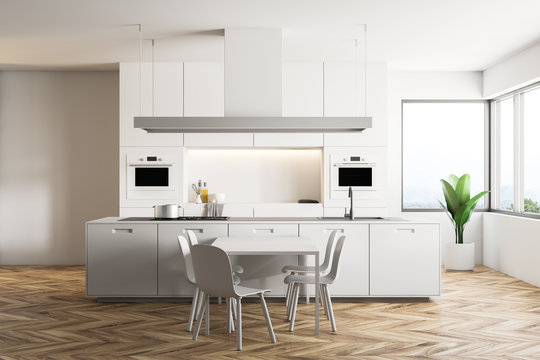 White kitchen interior with a table
