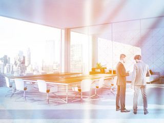 People in white triangle tile conference room