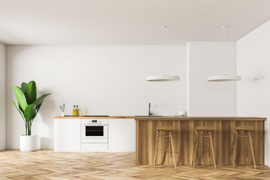 White kitchen interior with bar and stools