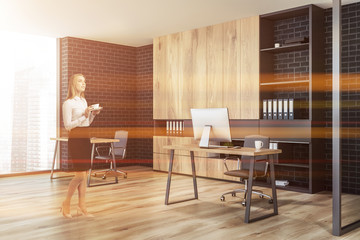 Loft office corner, black brick, businesswoman