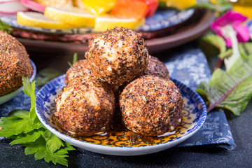 Cheese belper knolle in spices red and black pepper decorated with mint.