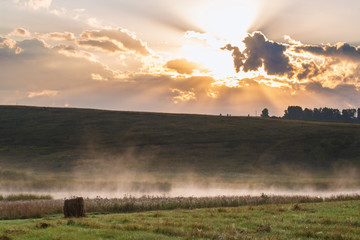 Fototapeta na wymiar Panoramic view of foggy countryside in sunset light 