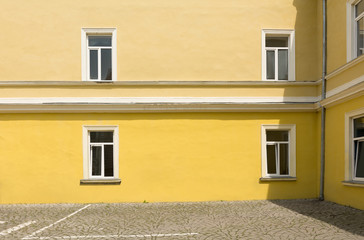 Traditional classic European restored school building facade with windows