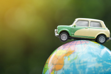Travel and transport concept, car on world map balloon with green nature background.