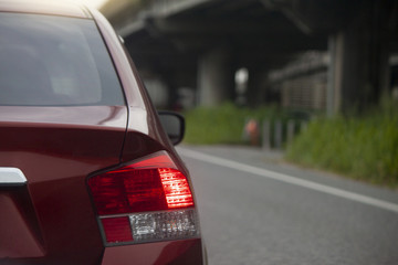 Naklejka premium Car break on the road in traffic junction at evening. Next to the bridge across the different levels.