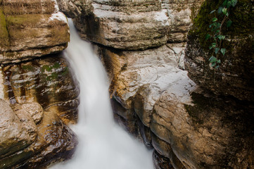 Beautiful rapid waterfall stream flowing among rocks in Martvili canyon on autumn day