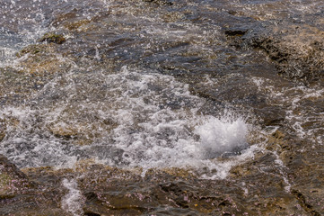 Sea water splashing on the rock