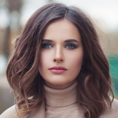 Naklejka premium Young beautiful female face closeup, portrait