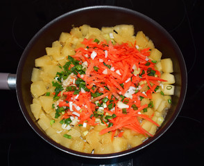  Stewed vegetables, zucchini, carrots, onions. Frying pan with stewed vegetables on the stove. The preparation of the meal