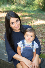 pretty brunette young woman with long hairs with cute son child boy in park