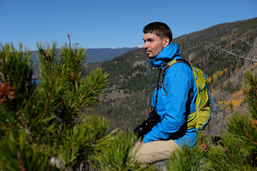 Naklejka premium Backpacker hiker tourist in Rocky Mountains