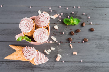 Sweet ice cream in a waffle horn on wooden background. Top view. Copy space