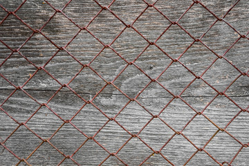 Fototapeta premium Wooden surface with metal mesh
